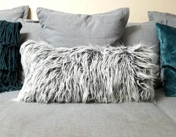 Una almohada de piel sintética en un sofá.