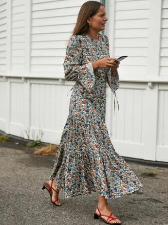 nowe marki sukienek dla gości weselnych: kobieta ubrana w kwiecistą sukienkę podczas tygodnia mody w Kopenhadze